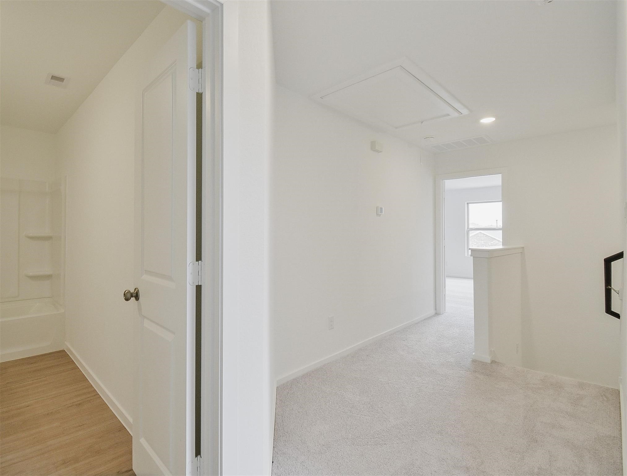 18566 Cepagatti Drive New Caney, TX 77357 - Photo 18 of 35 a view of a hallway with wooden floor