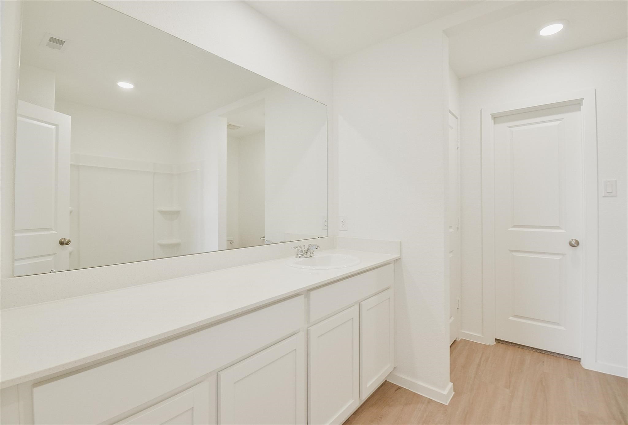 18566 Cepagatti Drive New Caney, TX 77357 - Photo 21 of 35 a bathroom with a sink and vanity