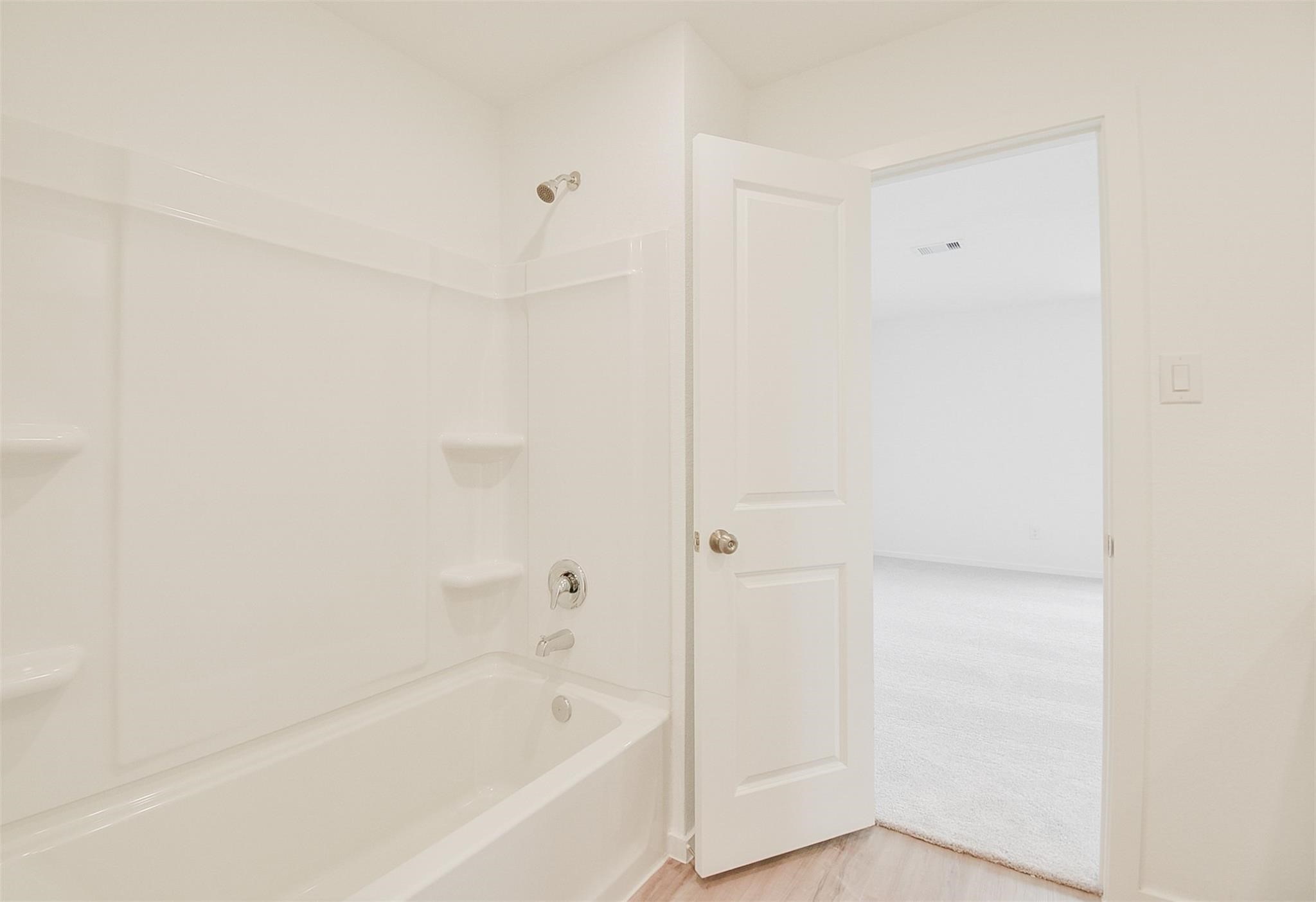 18566 Cepagatti Drive New Caney, TX 77357 - Photo 25 of 35 a bathroom with a bathtub
