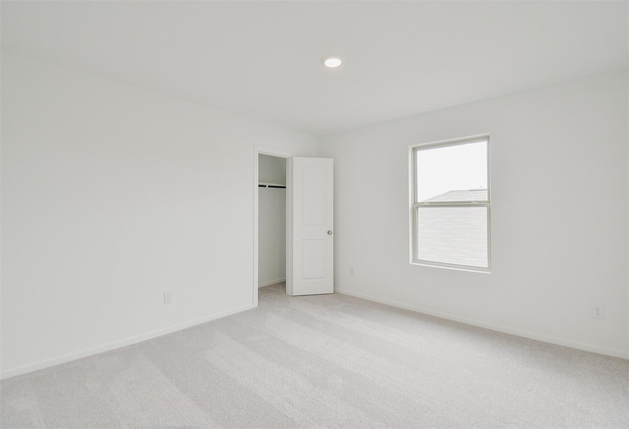 18566 Cepagatti Drive New Caney, TX 77357 - Photo 27 of 35 an empty room with a window