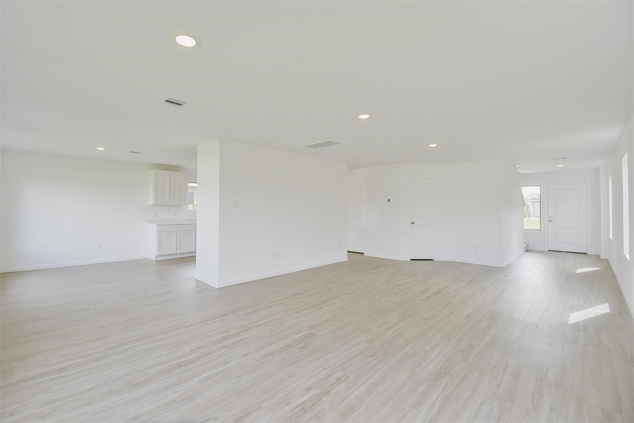 18566 Cepagatti Drive New Caney, TX 77357 - Photo 6 of 35 a view of empty room with wooden floor and windows