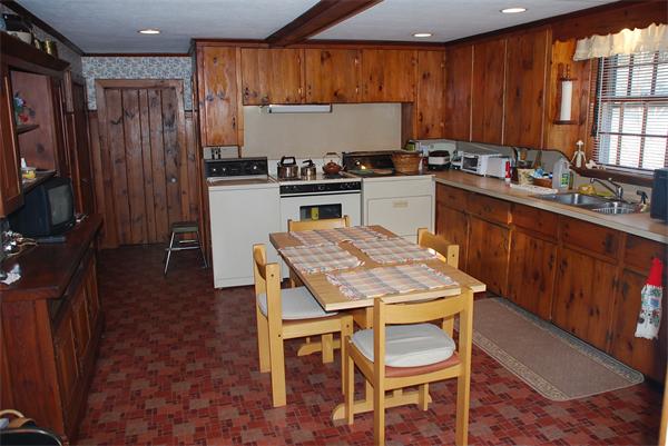 93 Argilla Road Andover, MA 01810 - Photo 11 of 28 a kitchen with granite countertop a table chairs stove and cabinets
