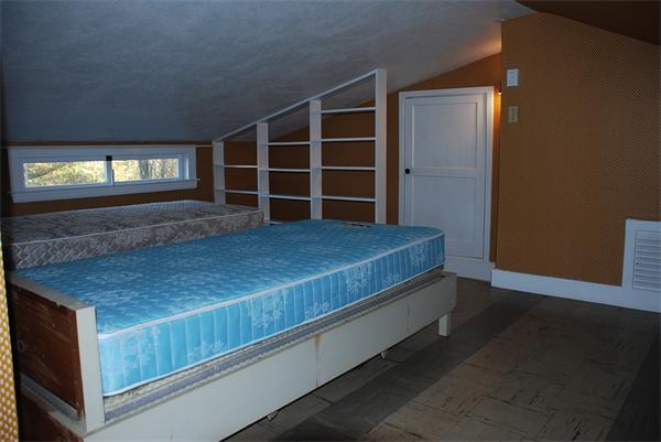 93 Argilla Road Andover, MA 01810 - Photo 13 of 28 a view of an empty room with a window and wooden floor