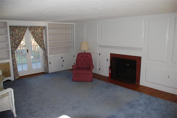 93 Argilla Road Andover, MA 01810 - Photo 18 of 28 a living room with furniture and a fireplace