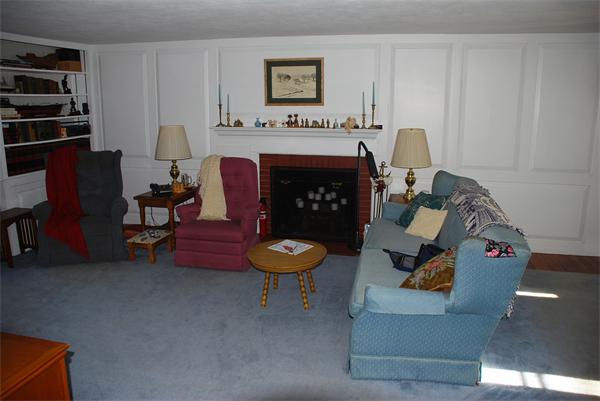 93 Argilla Road Andover, MA 01810 - Photo 3 of 28 a living room with furniture and a fireplace