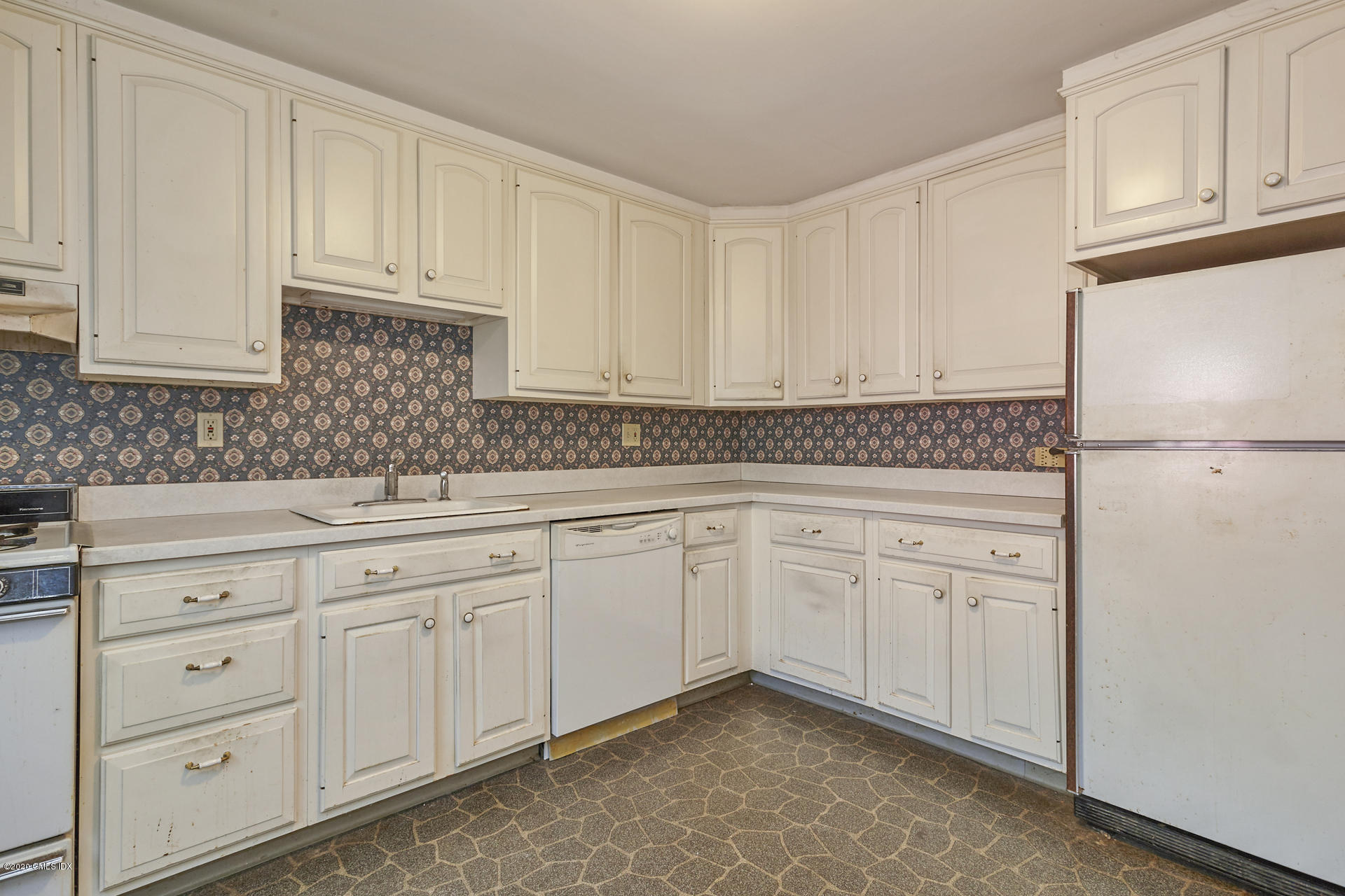 10 Hendrie Lane Riverside, CT 06878 - Photo 7 of 28 a kitchen with granite countertop white cabinets and white appliances