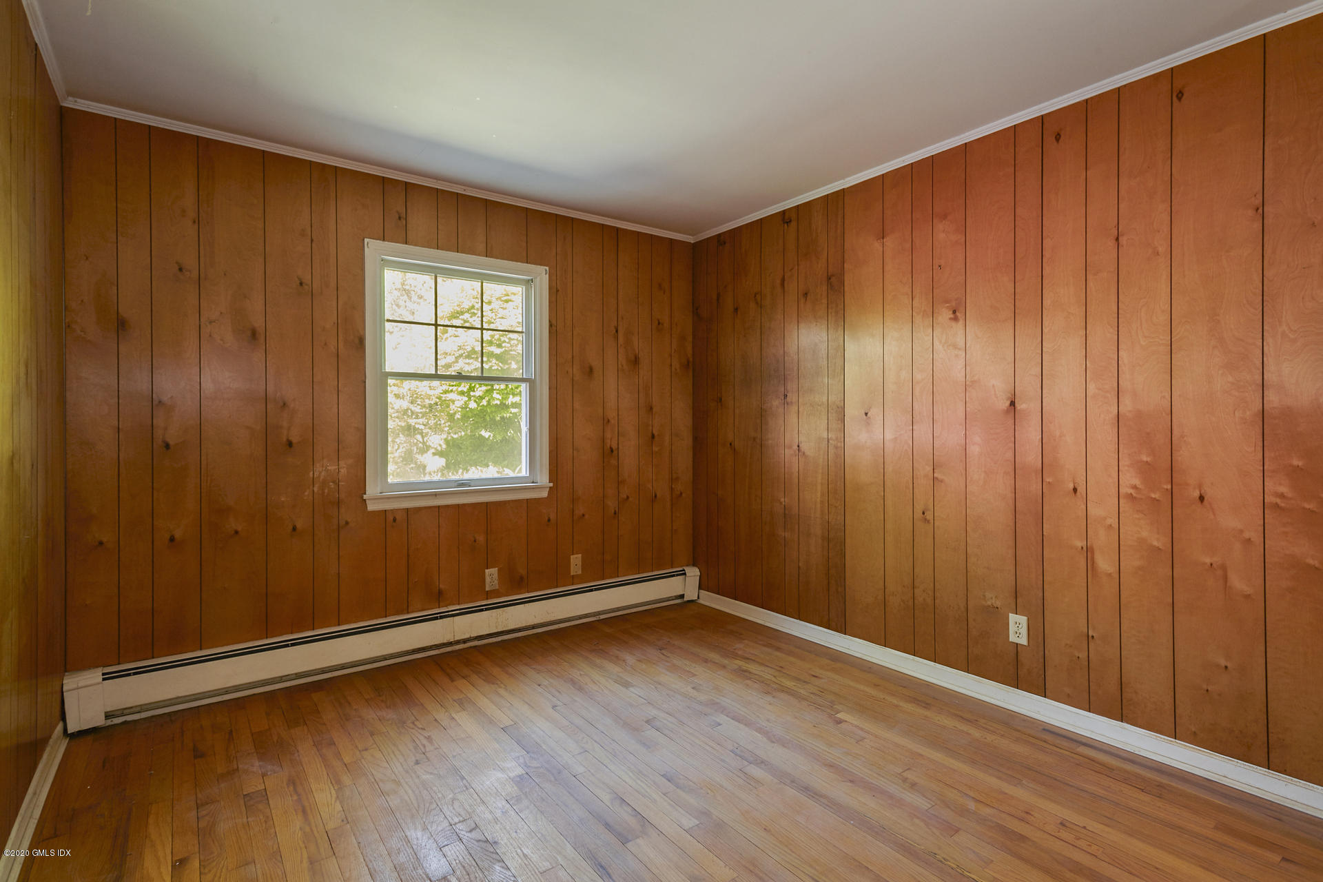 10 Hendrie Lane Riverside, CT 06878 - Photo 8 of 28 an empty room with wooden floor and windows with wooden walls