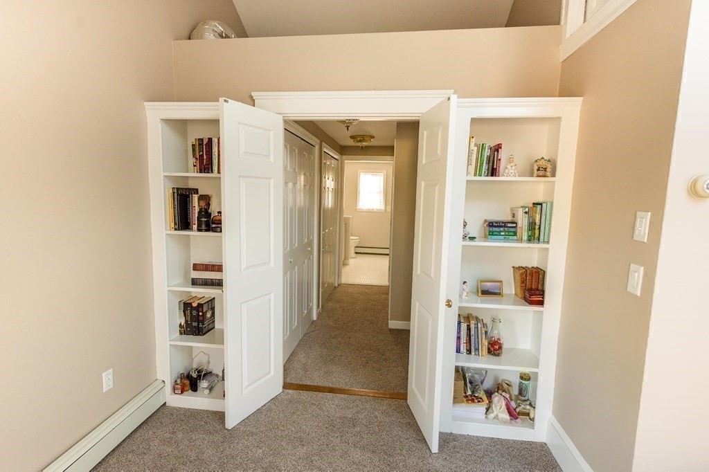 71 Waldeck Road Milton, MA 02186 - Photo 14 of 27 a view of a hallway with shelves