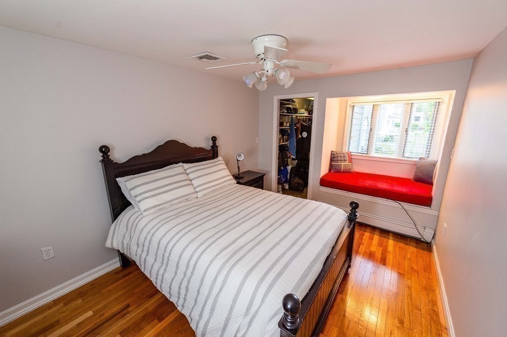 71 Waldeck Road Milton, MA 02186 - Photo 18 of 27 a bedroom with a bed and wooden floor