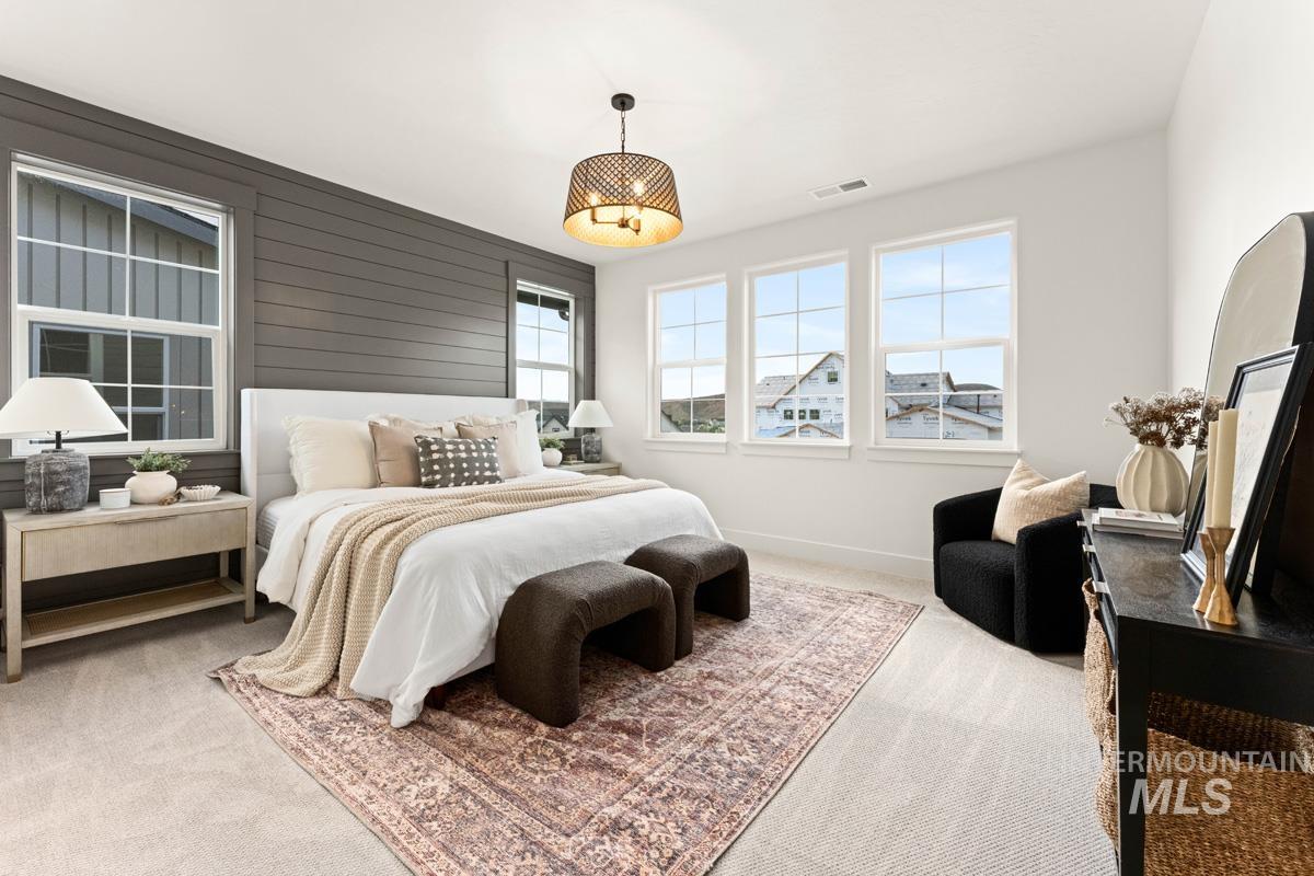 13338 North Spring Creek Way Boise, ID 83714 - Photo 17 of 46 Carpeted room featuring a shiplap accent wall, multiple windows, and a ceiling-mounted light fixture