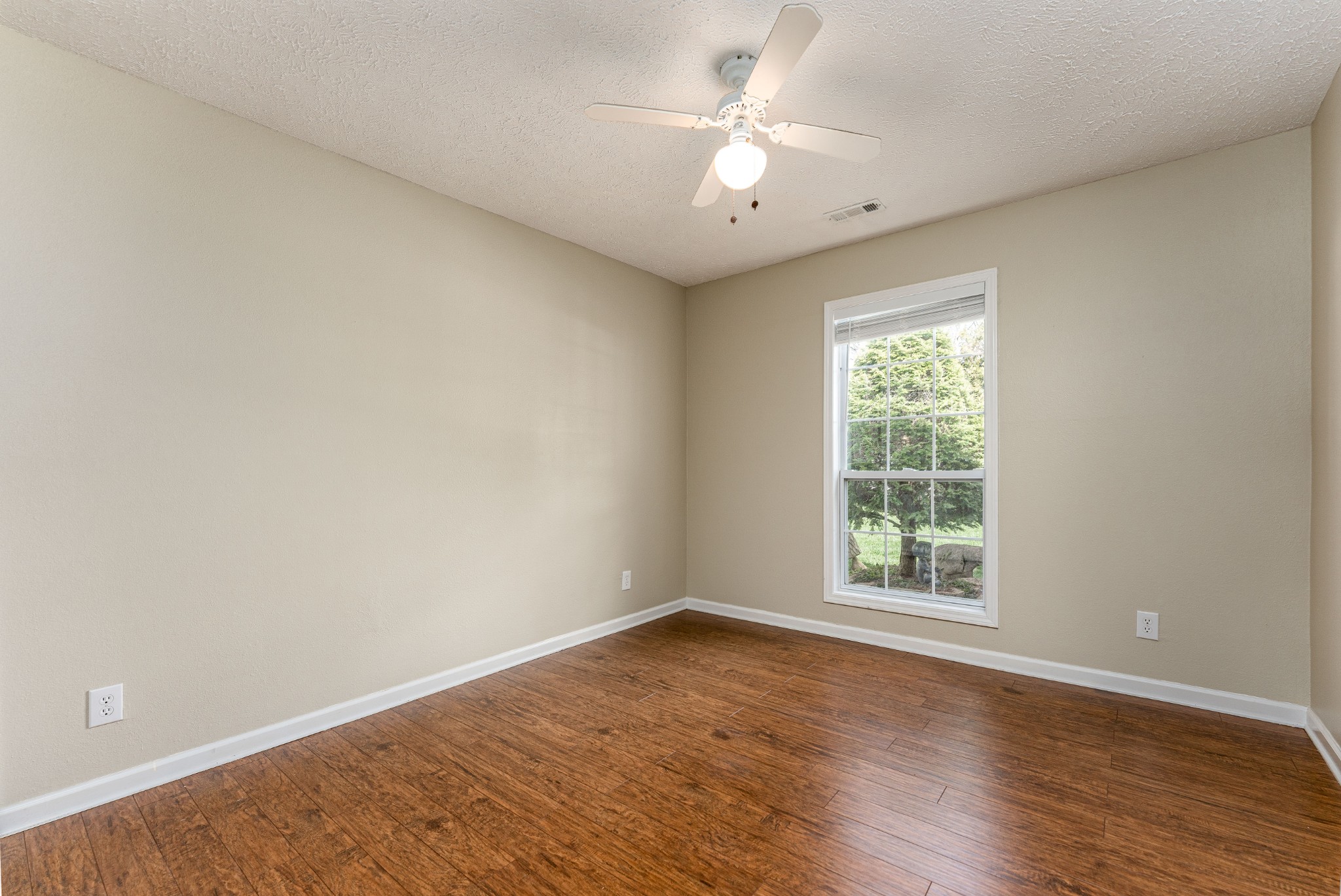 1243 Hunters Point Lane Spring Hill, TN 37174 - Photo 19 of 35 an empty room with wooden floor and window