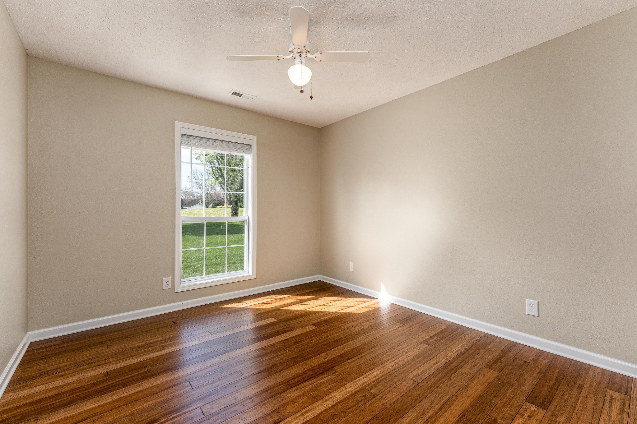 1243 Hunters Point Lane Spring Hill, TN 37174 - Photo 20 of 35 an empty room with wooden floor and windows