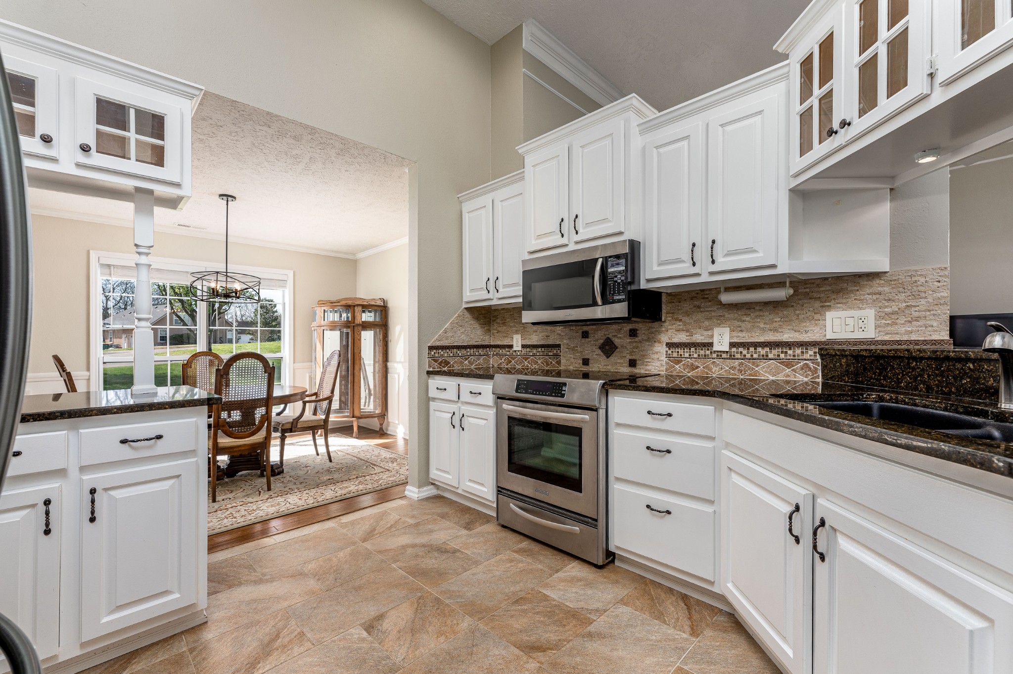 1243 Hunters Point Lane Spring Hill, TN 37174 - Photo 26 of 35 a kitchen with white cabinets and appliances