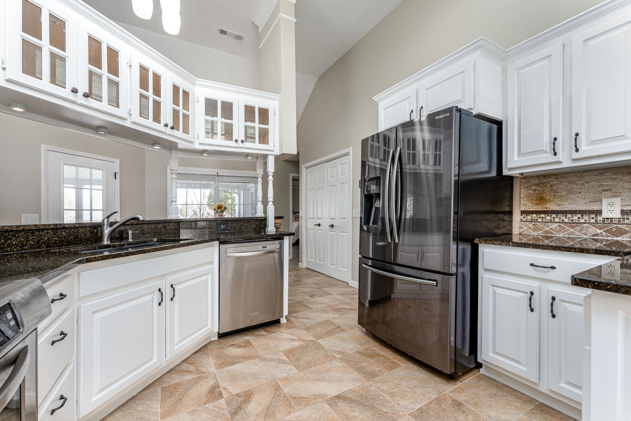 1243 Hunters Point Lane Spring Hill, TN 37174 - Photo 27 of 35 a kitchen with granite countertop a refrigerator and cabinets