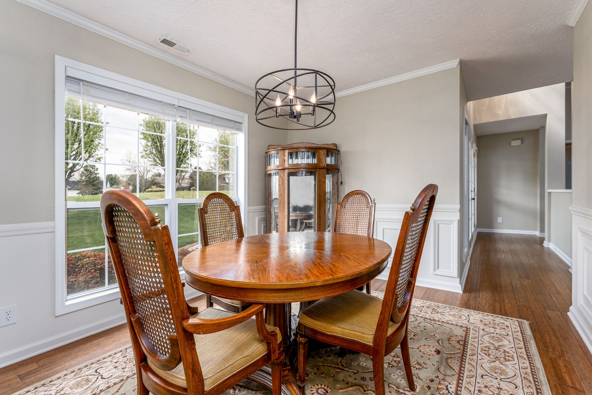 1243 Hunters Point Lane Spring Hill, TN 37174 - Photo 34 of 35 a dining room with furniture a chandelier and wooden floor