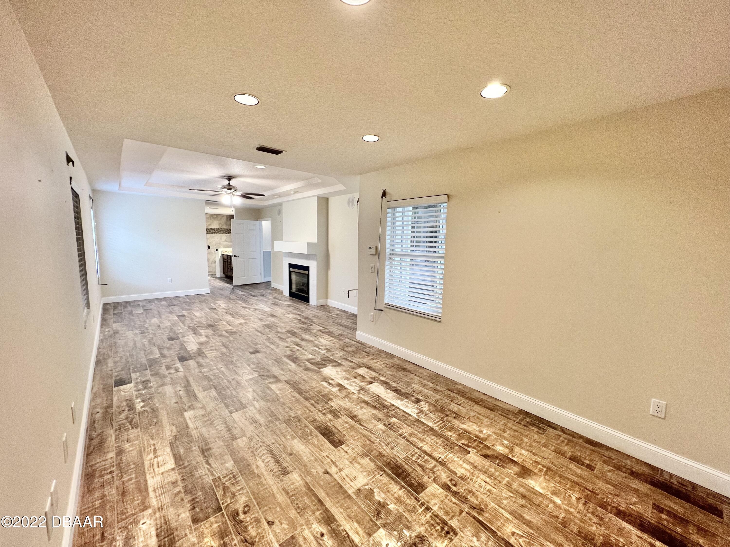 75 Creek Bluff Way Ormond Beach, FL 32174 - Photo 13 of 20 a view of empty room with wooden floor and fan