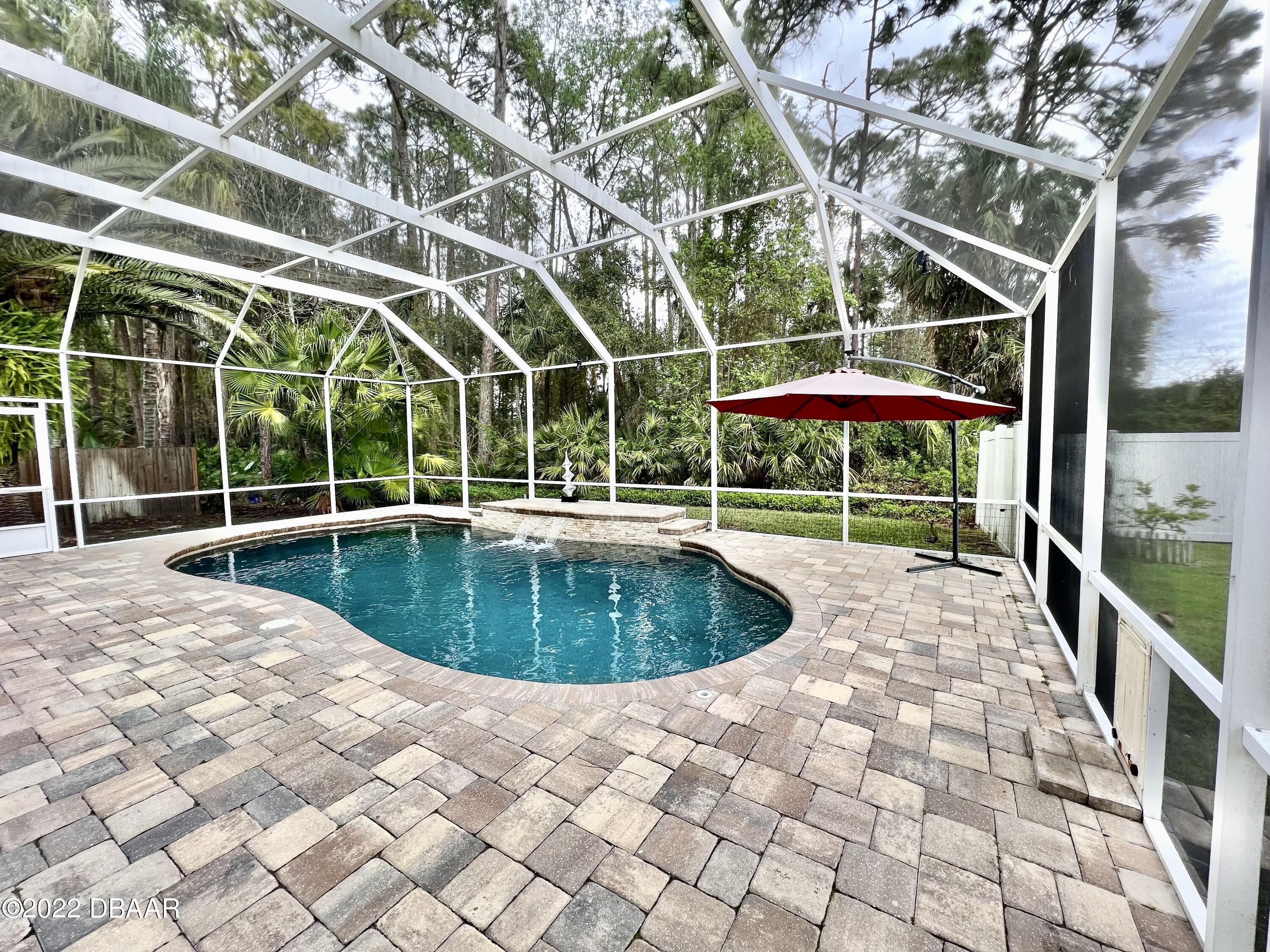 75 Creek Bluff Way Ormond Beach, FL 32174 - Photo 19 of 20 a view of a swimming pool with a patio