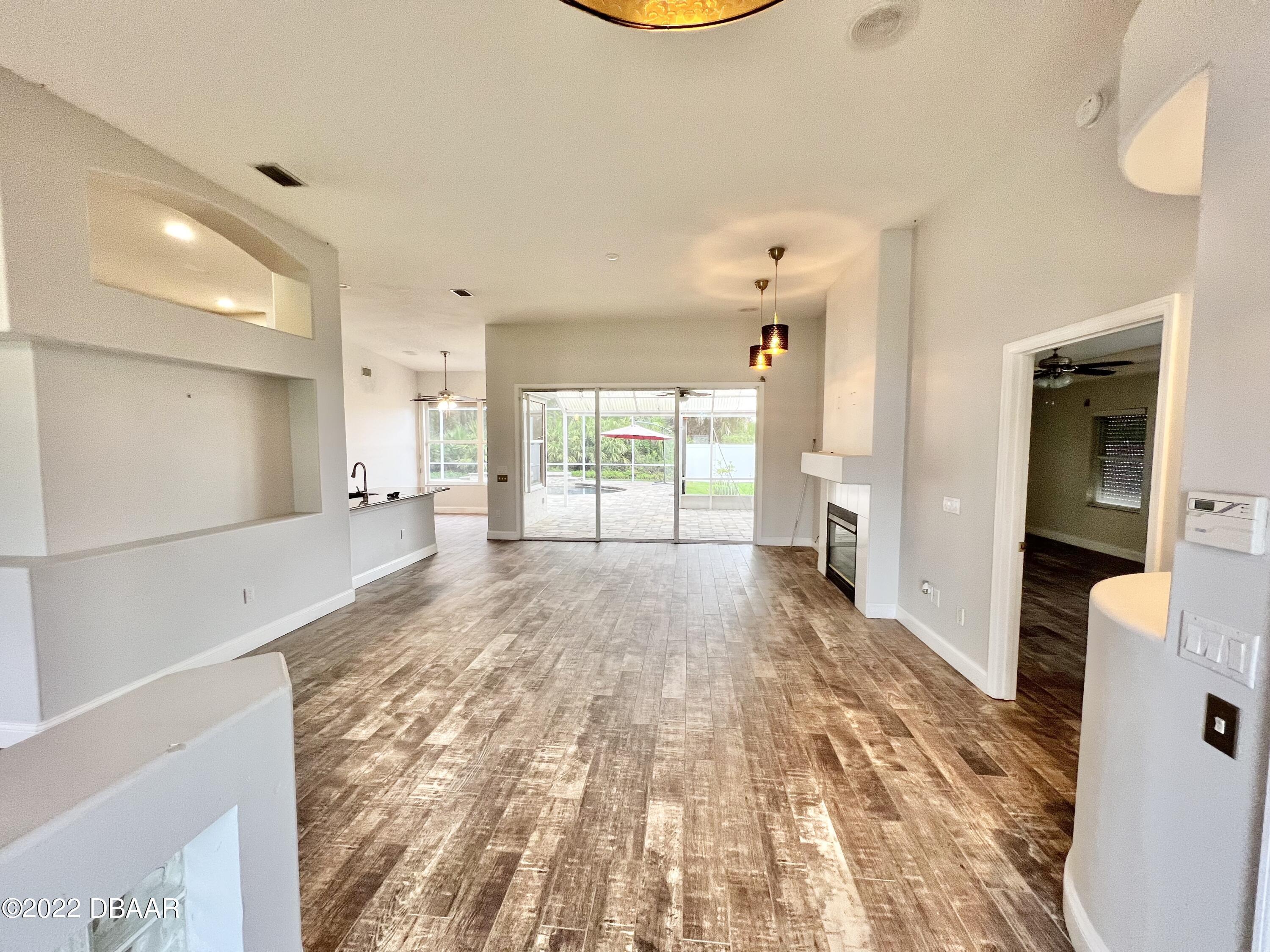 75 Creek Bluff Way Ormond Beach, FL 32174 - Photo 3 of 20 a view of a big room with wooden floor and windows
