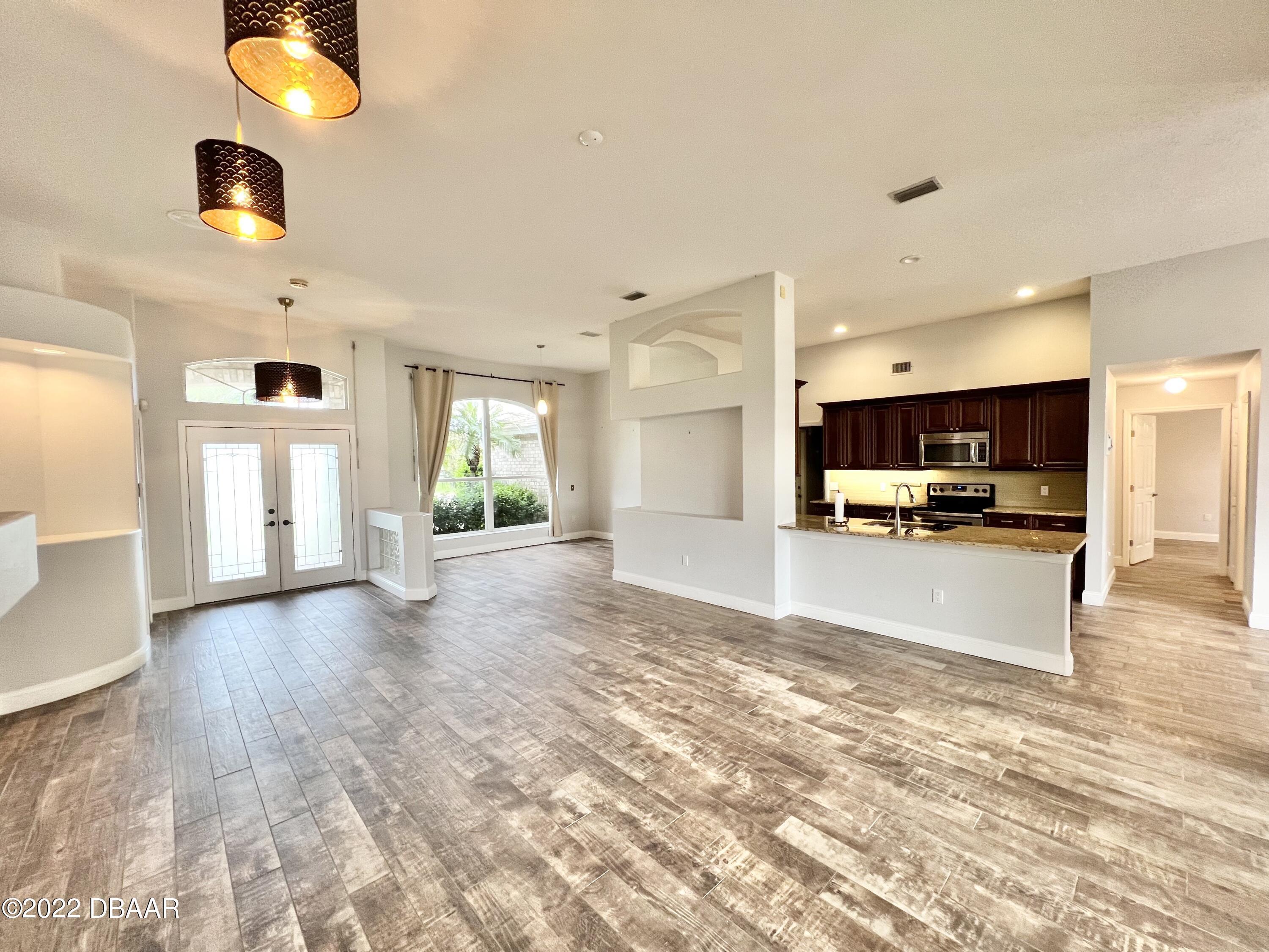 75 Creek Bluff Way Ormond Beach, FL 32174 - Photo 9 of 20 a view of kitchen with cabinets and wooden floor