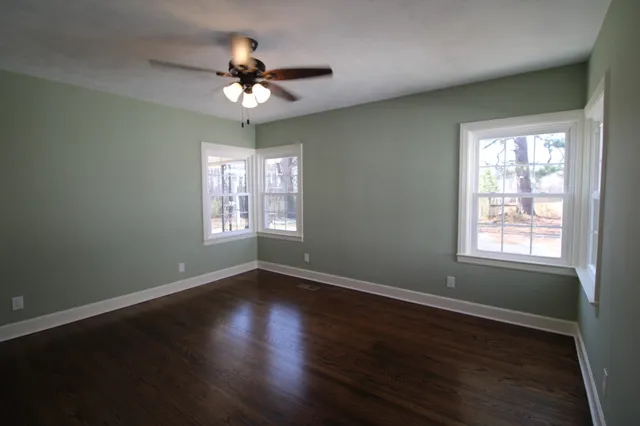 a bathroom with a granite countertop sink toilet and mirror