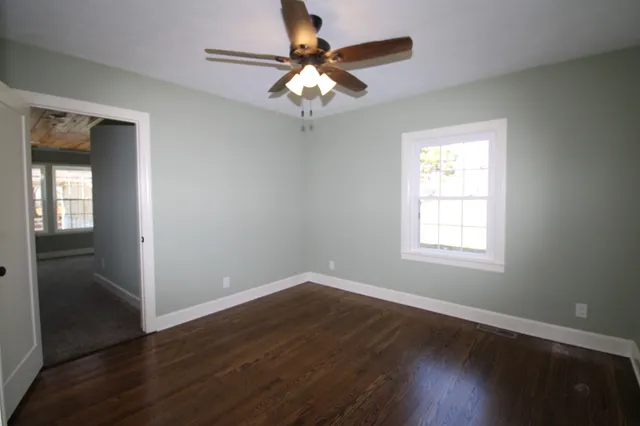 a bathroom with a granite countertop toilet and a sink