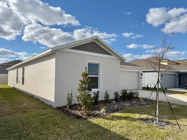 a backyard of a house with table and chairs