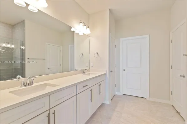 a spacious bathroom with a double vanity sink mirror and