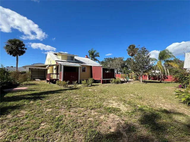 a view of a house with a yard and plants