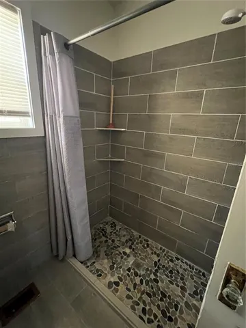 a bathroom with a shower and a toilet