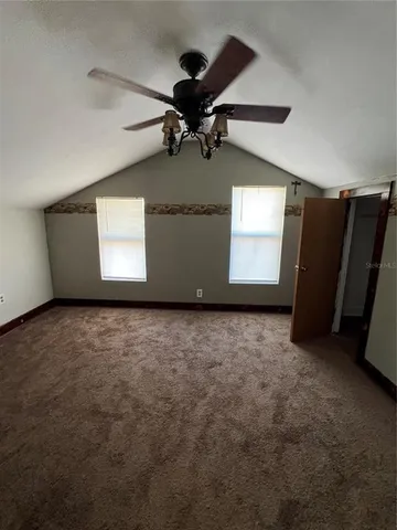 a view of a livingroom with a ceiling fan and window