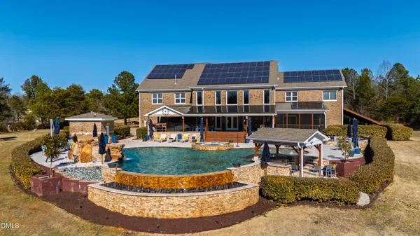 a living room with furniture kitchen view and a wooden floor