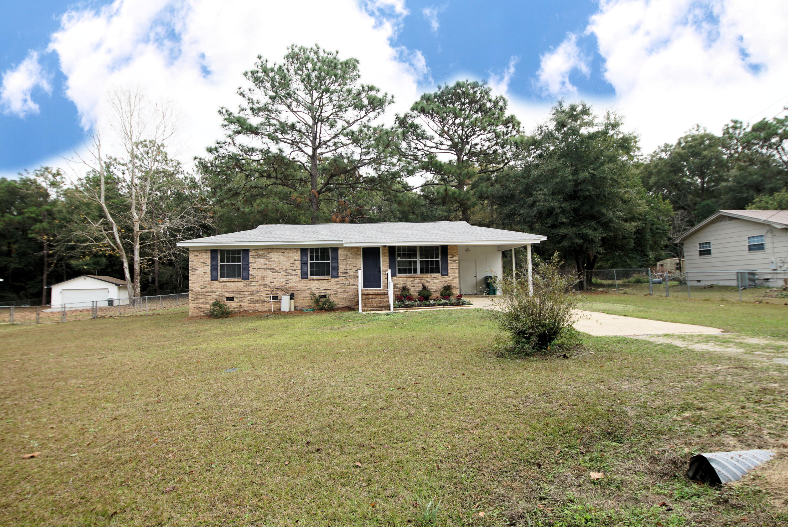 681 Ridge Lake Road Crestview, FL 32536 - Photo 4 of 31 a front view of a house with a garden and trees