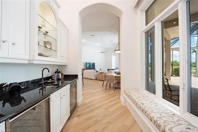 a kitchen with granite countertop a sink and cabinets