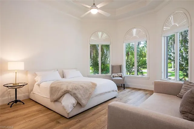 a living room with a bed furniture and a large window