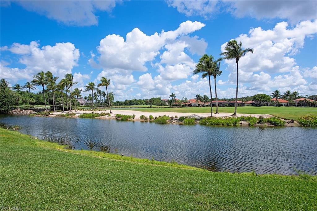 1633 China Berry Way Naples, FL 34105 - Photo 2 of 40 a view of a lake with houses in the background