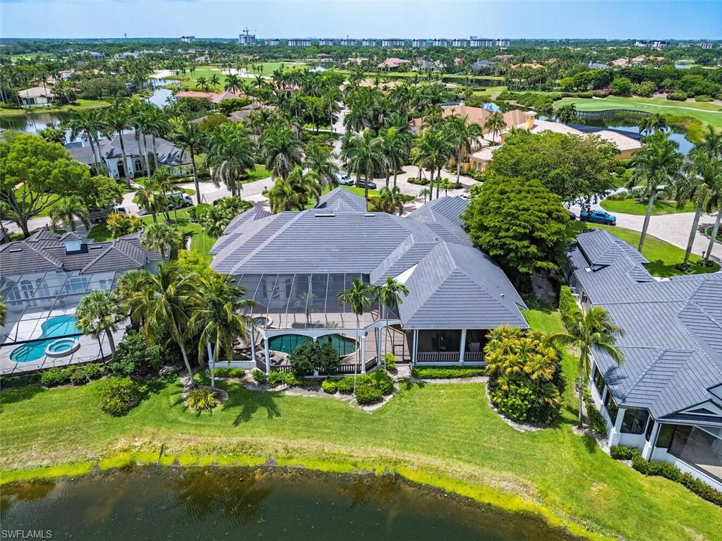 1633 China Berry Way Naples, FL 34105 - Photo 24 of 40 a view of a house with a garden and yard
