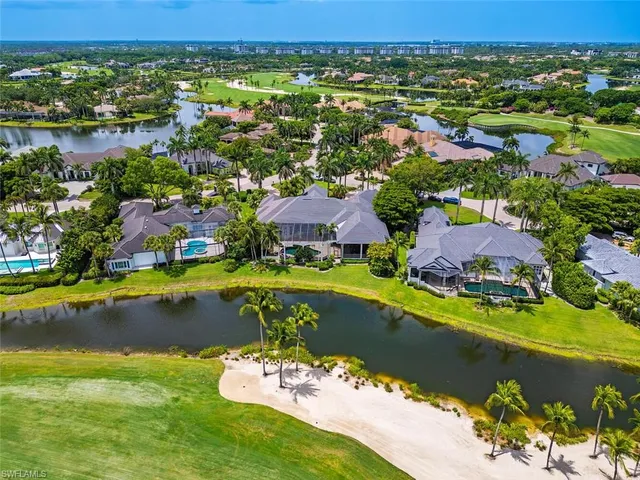 an aerial view of residential houses with outdoor space and lake view