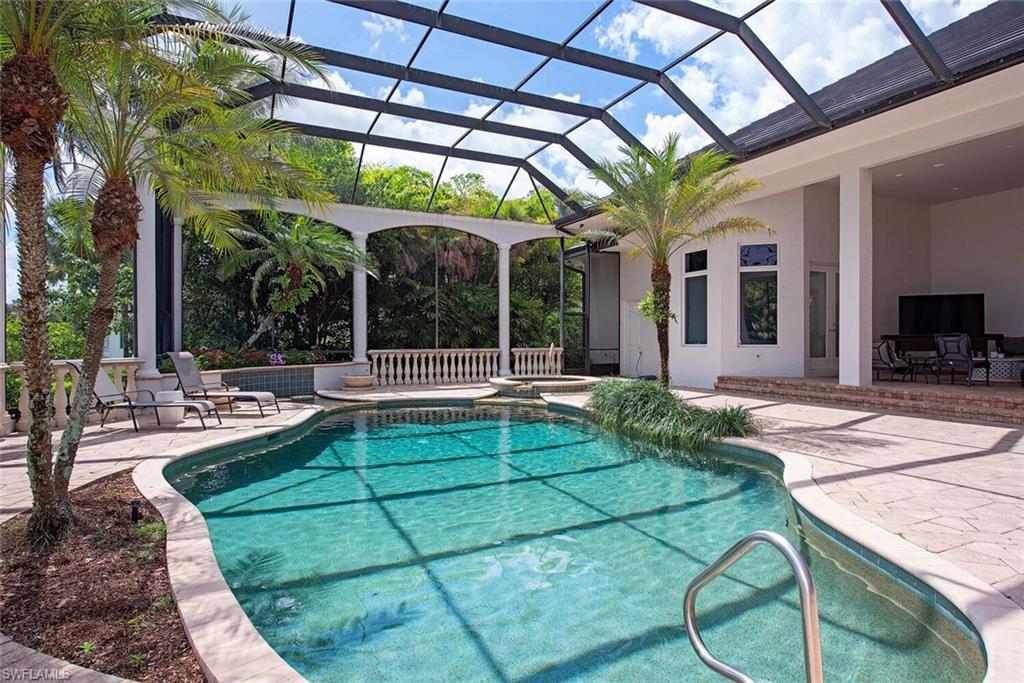 1633 China Berry Way Naples, FL 34105 - Photo 3 of 40 a view of a swimming pool with a patio