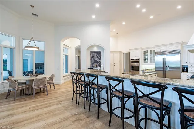 a view of a a dining room with furniture window and wooden floor
