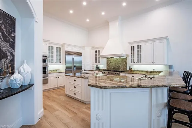 a kitchen with stainless steel appliances granite countertop a sink and cabinets