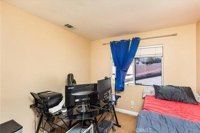 a view of a living room with furniture and wooden floor