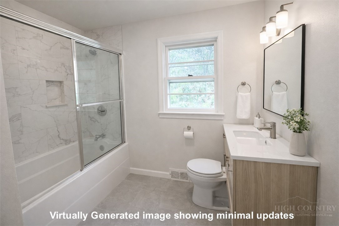 2510 Rich Hill Road Creston, NC 28615 - Photo 14 of 38 a bathroom with a sink a toilet and a shower