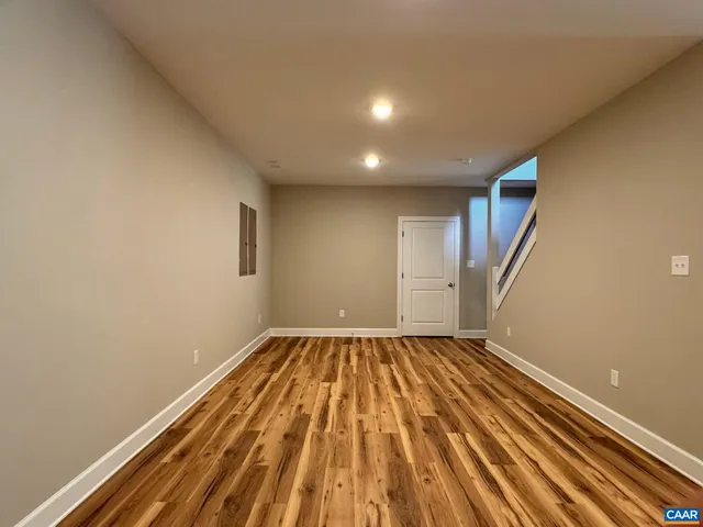 a view of kitchen with wooden floor and electronic appliances