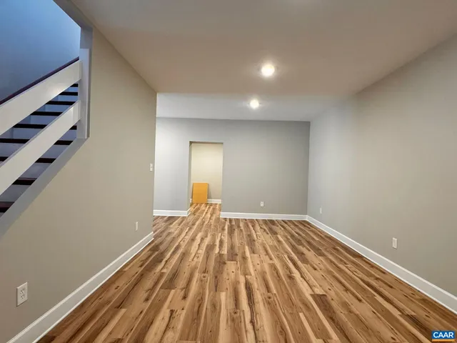 a view of a room with wooden floor and window
