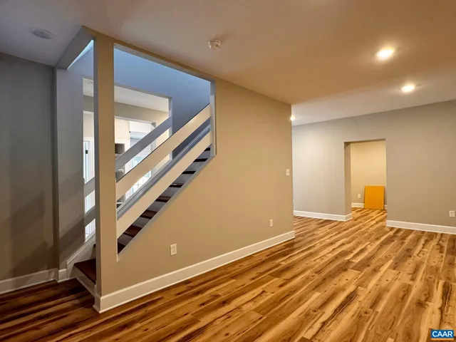 a view of a room with wooden floor and window