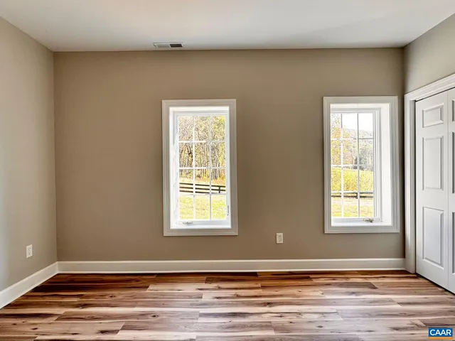 a view of a room with wooden floor and stairs