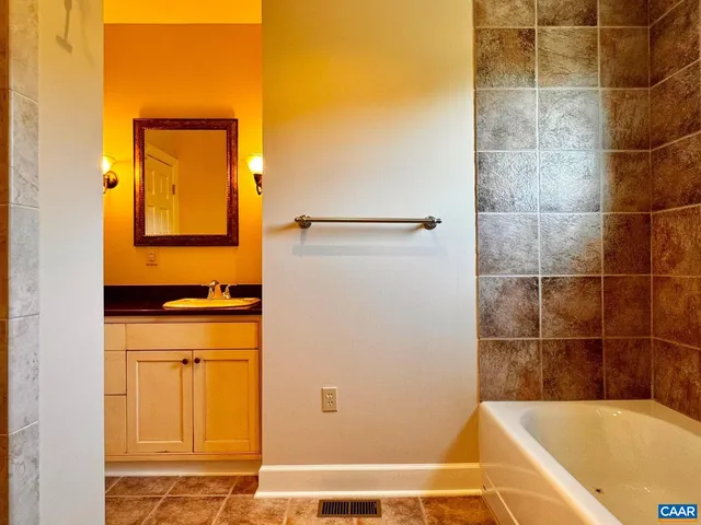 an empty room with wooden floor and natural light