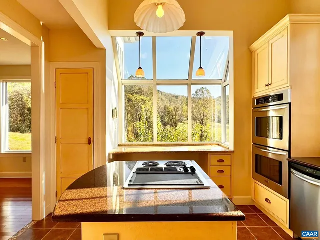 a living room with fireplace and wooden floor
