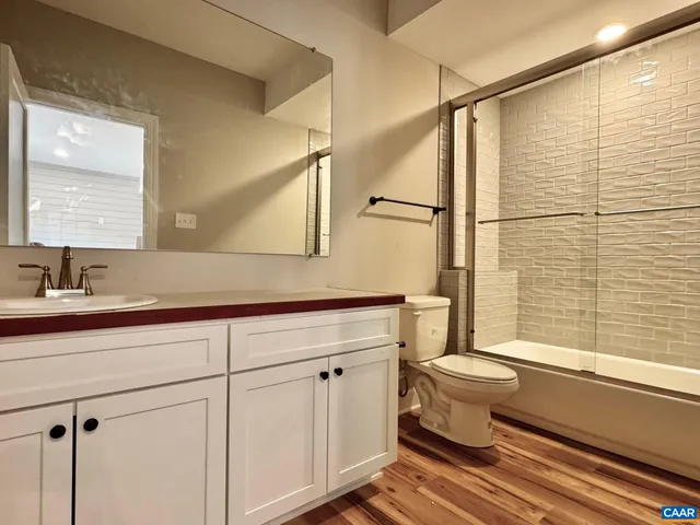 a view of a livingroom with wooden floor and a fireplace