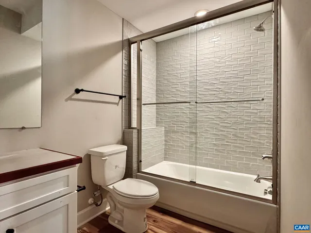 a view of a livingroom with wooden floor and staircase